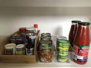 Should I put my clutter into containers? Yes, kitchen products are lined up neatly in containers