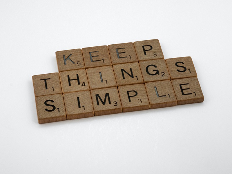 Simplify your life. Scrabble tiles say Keep Things Simple in that order on a white background