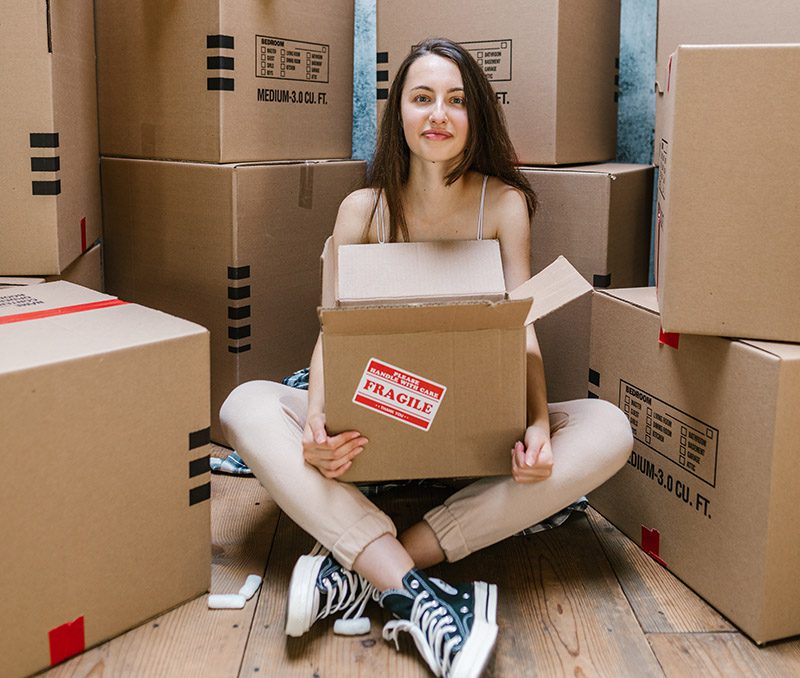 decluttering and the endowment effect - a lady clutches a box of belongings
