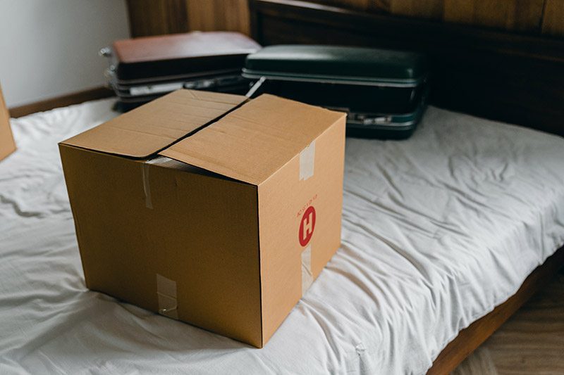 intergenerational clutter - a brown box sits on the bed