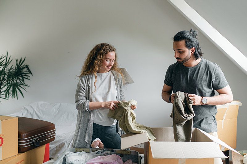 Decluttering to move house - a couple sorts through their belongings