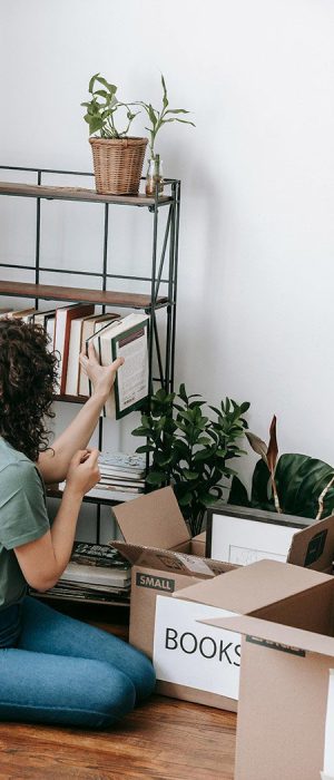 Decluttering and Organising with My Aged Care - workers unpack boxes onto a shelf