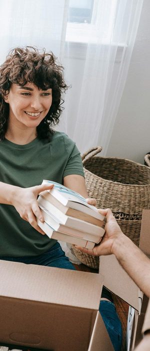 Decluttering poor mental health. An assistant helps a person declutter books